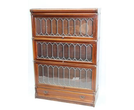 A MAHOGANY GLOBE-WERNICKE DESIGN BOOKCASE WITH THREE LEADED GLAZED DOORS the plinth fitted a single full width drawer 124cm x