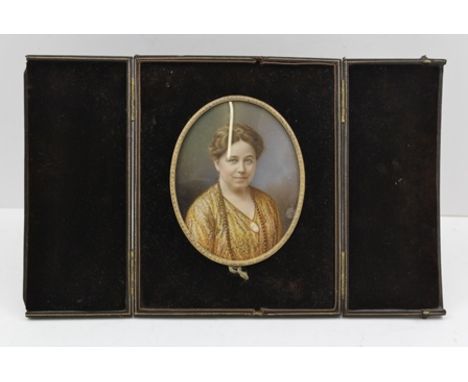 A LATE VICTORIAN PORTRAIT MINATURE OF A WOMAN, Watercolour painting, in oval frame, 12cm x 9.5cm, in a folding leather easel 