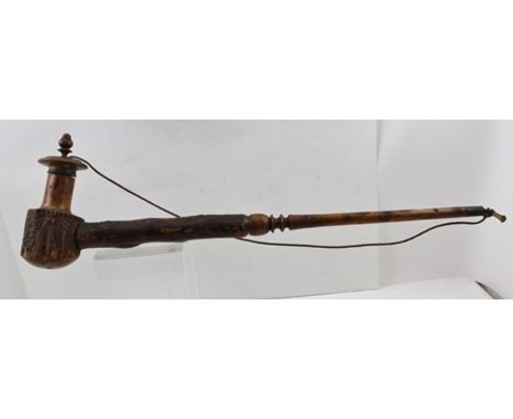 A SOUTH AFRICAN WOODEN TOBACCO PIPE from the Kosa Tribe with bowl cover, 68cm long 