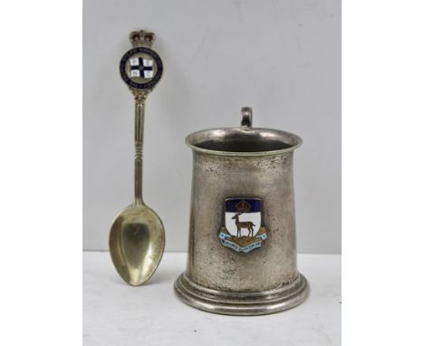 A SILVER PLATED MUG with enamel crowned shield, Orange River Colony SA c.1900, together with an ENAMELLED SPOON, Pacific Navi