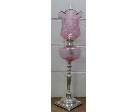 A silver plated and cranberry glass lamp, 76cm
