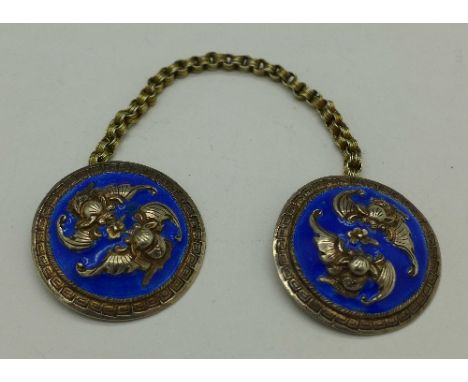 A pair of white metal and enamel cloak buttons
