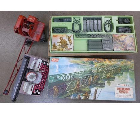 A Tri-ang crane, a pontoon bridge and a Mettoy typewriter
