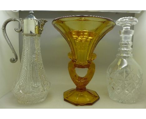 A cut glass decanter, claret jug and treacle glass vase