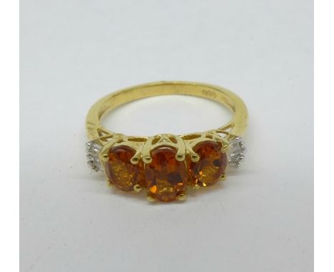 A silver gilt ring set with Madeira citrine and ten diamonds, K/L