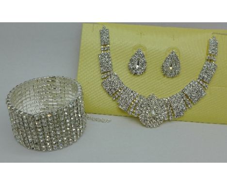A diamante necklace with a matching pair of earrings and a diamante bangle