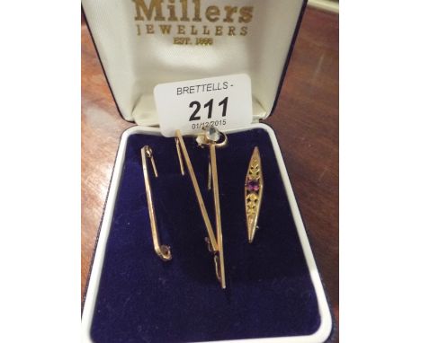 Three Tie and Stock Pins and A Brooch.