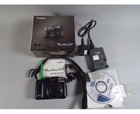 A Canon Power Shot G12 Digital Camera with Charger and Original Box Instruction and Disk. 