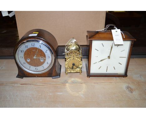 A 1970's Smiths mantel clock; a Smiths reproduction lantern clock; and a 1930's oak cased mantel clock.  (3)