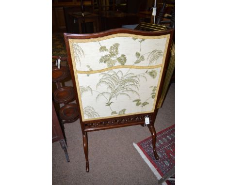An early 20th Century stained wood firescreen, the serpentine top above double sided panel, with Japanese print to one side a