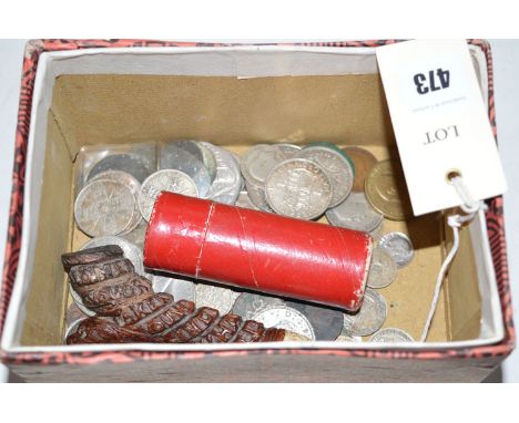 A box of coins; and part of a carved wood pipe.