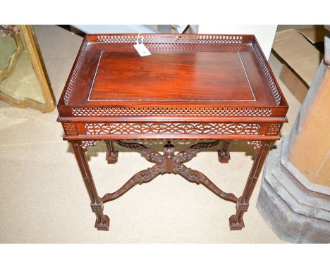 A reproduction Chinese Chippendale style silver table, with pierced gallery frieze and stretcher, holding turned triple colum