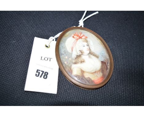 A late 19th Century Italian miniature portrait of a lady wearing a lace-trimmed bonnet, indistinctly signed "A. M***", in gil