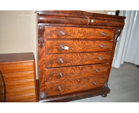 A Victorian mahogany Scotch chest of six drawers with carved corbels and turned bun feet; and a magazine rack.