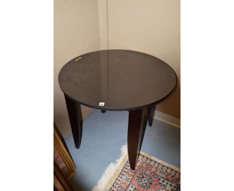 A circular marble occasional table, raised on tapering square profile ebonised legs; and a modern console table with shaped g