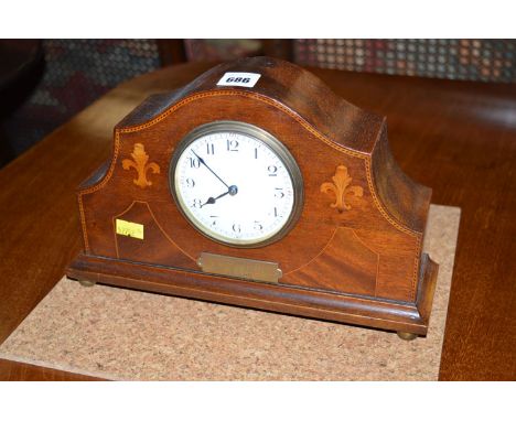 An Edwardian inlaid mahogany mantel clock, the white enamel arabic dial within a serpentine case decorated with floral inlay 