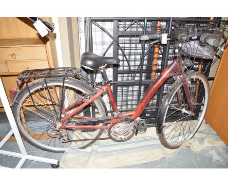 A lady's Orbea bicycle with a basket on the front, fitted mudguards and chain guard; together with a safety helmet.