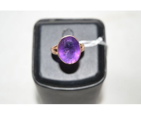 An amethyst ring, the oval facet cut amethyst collet set in rose gold mount, ring size R.