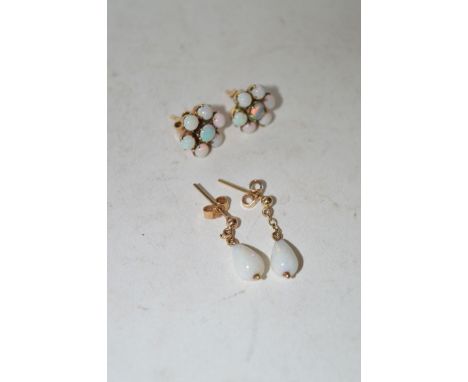 A pair of drop opal earrings of pear-form; together with a pair of opal cluster stud earrings in yellow metal mounts.