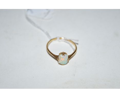 An opal ring, the canted rectangular opal four claw set on yellow metal shank stamped '18ct.', ring size R.