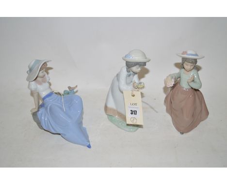 Three Nao figures of young girls.