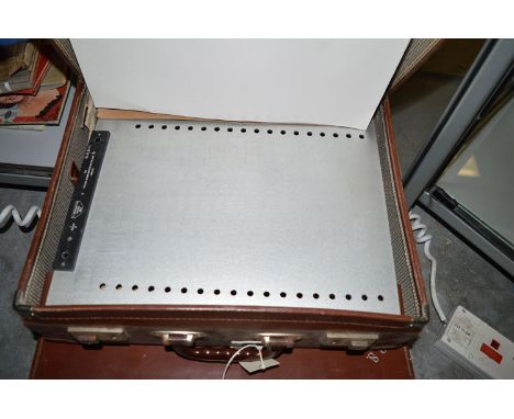 An attaché case containing a brail typewriter.