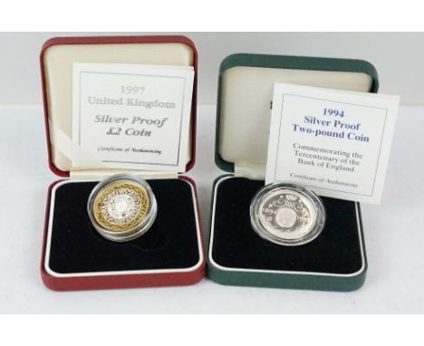 Two Royal Mint United Kingdom silver proof £2 coins to include 1994 and 1997 examples, both encapsulated within fitted displa
