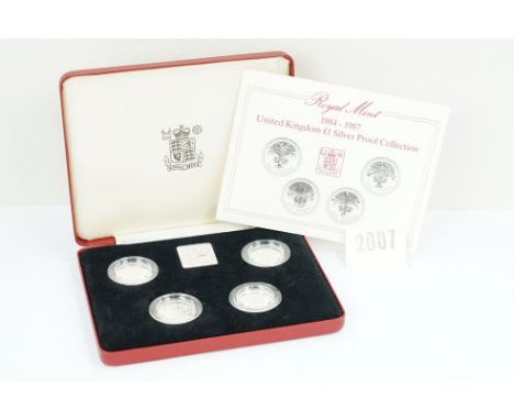 A Royal Mint Queen Elizabeth II 1984-1987 £1 silver proof four coin set, encapsulated within fitted display case and complete