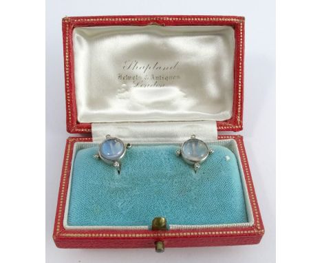 A pair of moonstone and diamond earrings, the round cabochons, of approximately 8.5mm diameter, with one single cut to each o