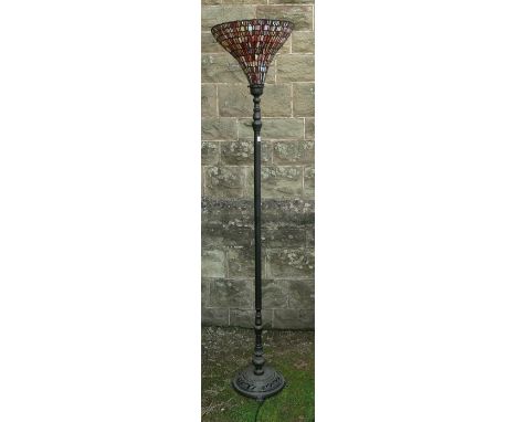 A Tiffany style standard lamp, with leaded coloured glass shade, on a pierced base, height 69ins