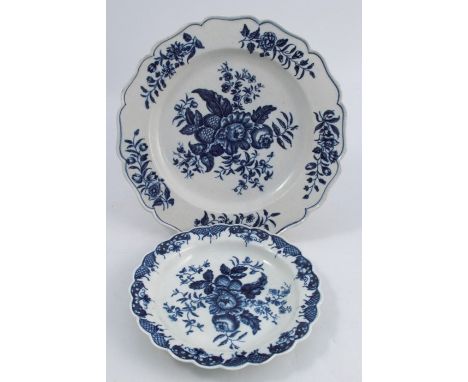 A First Period Worcester plate, decorated in the blue and white Pine Cone pattern, to a shaped edge, crescent mark to base, d