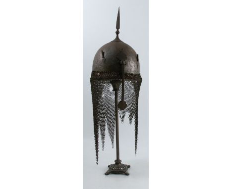 An 18th century Kulah Khud Persian helmet,&nbsp;with sliding nasal bar, two plume holders, square section spike, chain neck d
