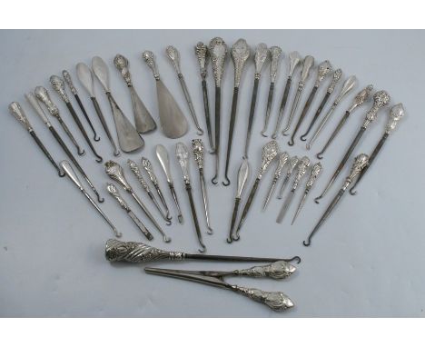 A collection of Victorian and Edwardian hallmarked silver handled button hooks, manicure tools, a pair of glove stretchers an