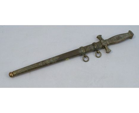 A reproduction German style dagger, with embossed brass hilt and scabbard
