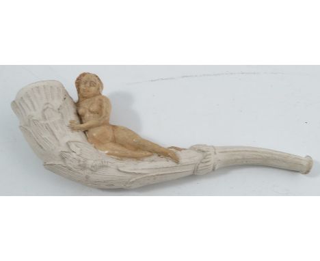 A 19th century clay pipe, moulded with leaves and a recumbent female nude, length 4.5ins