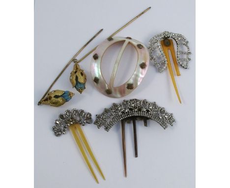 Two cut steel hair combs, together with a paste hair comb, two Victorian gilt metal hair pins and a mother of pearl buckle