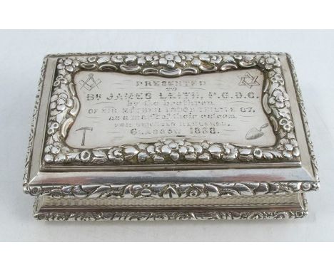 A 19th century silver table snuff box, of rectangular form, with raised floral border, the top engraved with Masonic symbols 