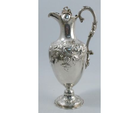 A 19th century silver claret jug, of baluster form, with vine finial to the hinged cover, vine handle and the body and pedest