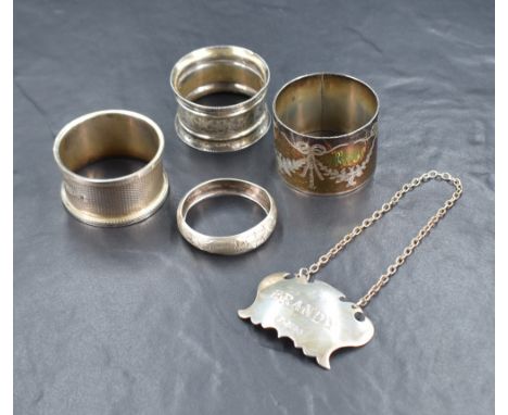 Four silver napkin rings, one having engine turned decoration, one with engraved foliage swags, the others with decorative en