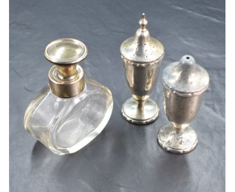 A George VI silver pepperette and salt, of traditional form with tapered bodies raised on circular step moulded feet, marks f