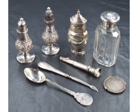 A pair of Victorian silver pepperettes, of traditional form having embossed scroll decoration, marks for Birmingham 1895, rub