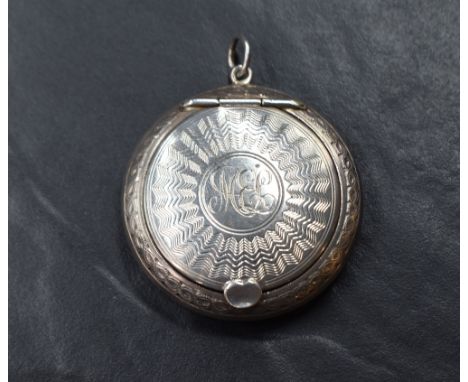 A George VI silver powder compact, of circular form having engine turned decoration with central circular cartouche engraved 