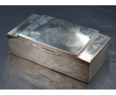 A George V silver cigarette box, of hinged rectangular form with engine turned decoration to lid, sandalwood lined interior, 