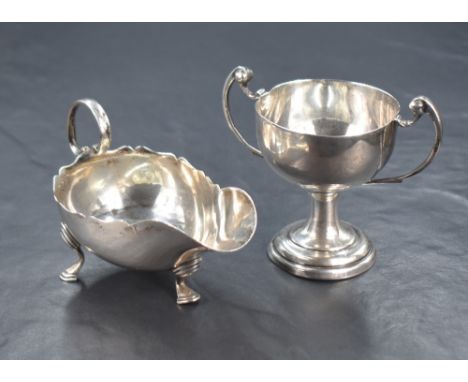 A Victorian silver sauce boat of traditional form, with Chippendale style rim and generous spout opposed by a scrolling handl