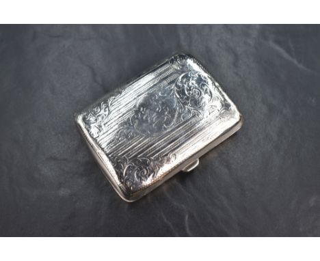 An Edwardian silver cigarette case of hinged rectangular form, having engraved floral scroll and vertical line decoration wit