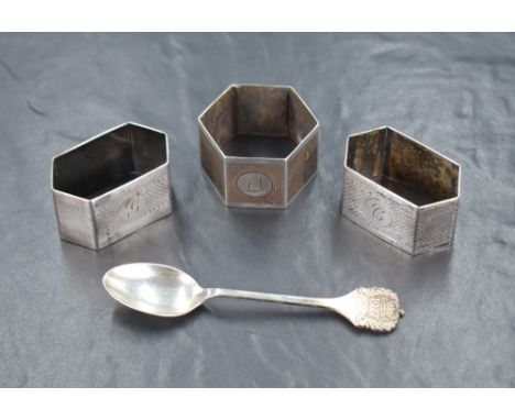 Three early 20th century silver napkin rings, all of hexagonal form having engine turned decoration and engraved central cart