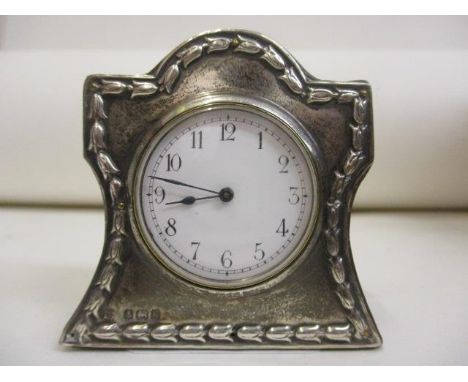 An early 20th century silver fronted miniature clock, hallmarked Birmingham 1906, makers marks W J M & Co. The white enamel d