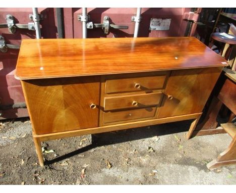 A Gordon Russell of Broadway, a mid 20th century teak sideboard with two cupboards, flanking three drawers and standing, on t