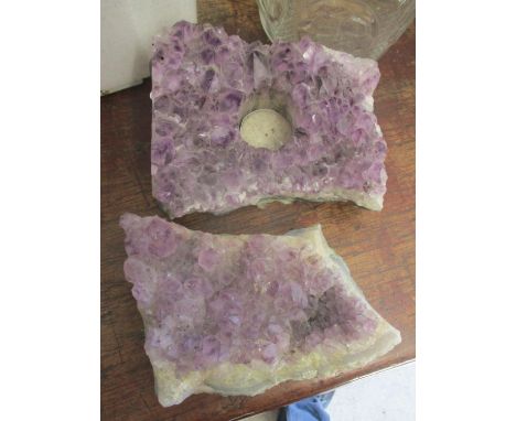 Two amethyst stones, on a candle holder 