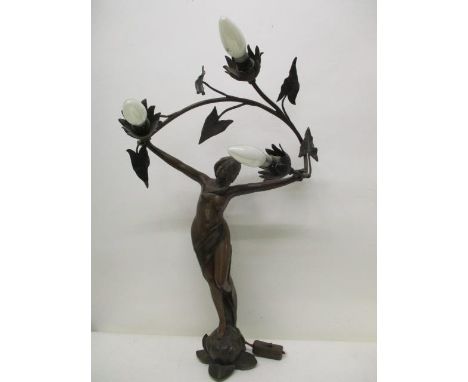 After L Beck an Art Nouveau cast spelter lamp fashioned as a woman holding a vine with three light sockets, on a lily, 25" h 